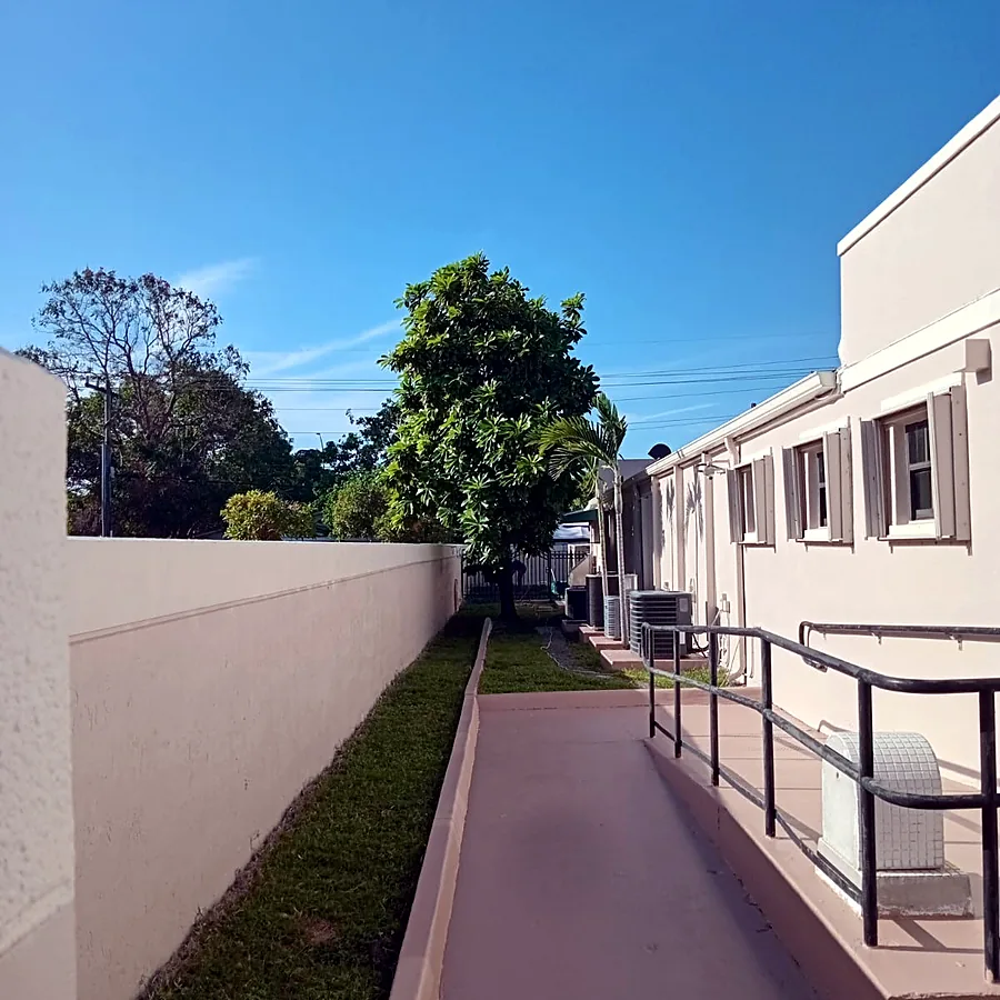 Repainted perimeter wall and walkway alongside a building